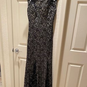 Black lace nude dress with diamond accents and a train